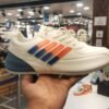 athletic shoe with blue and orange strips accents displayed in a store, ideal for morning walks and running.