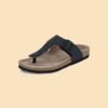 Black thong sandal with a cork sole, adjustable buckle strap, and ergonomic footbed, designed for comfort and casual wear.
