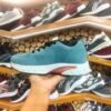teal-colored running shoe with a white cushioned sole and black laces