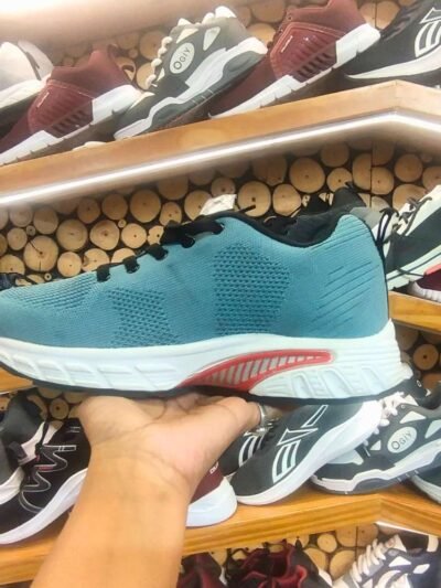 teal-colored running shoe with a white cushioned sole and black laces
