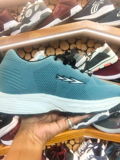 teal-colored running shoe with a white cushioned sole and black laces.