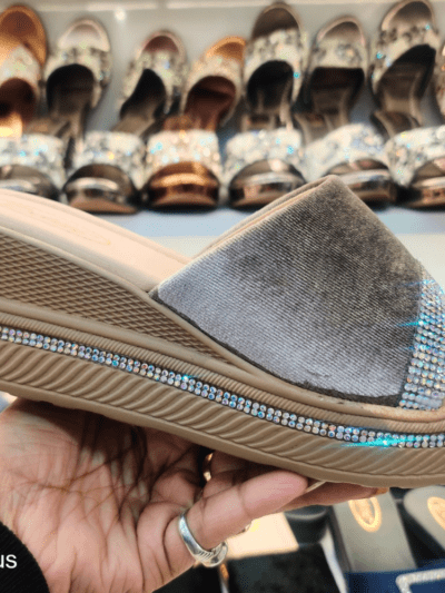 A stylish women’s platform sandal with Open Toe Textured, cushioned footbed, and rhinestone-embellished sole, displayed in a footwear store.