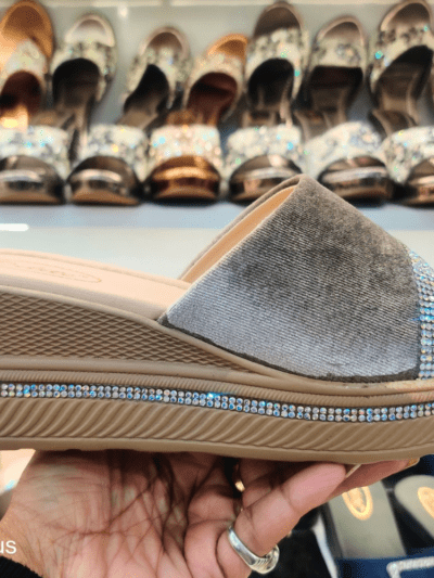 A stylish women’s platform sandal with Open Toe Textured, cushioned footbed, and rhinestone-embellished sole, displayed in a footwear store.
