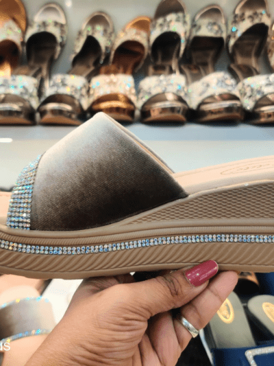 A stylish women’s platform sandal with Open Toe Textured, cushioned footbed, and rhinestone-embellished sole, displayed in a footwear store.